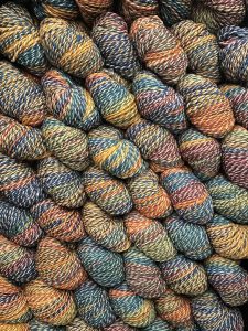 Multicolored Cheviot Dyed-in-the-Wool DK yarn skeins for knitting and crafting.
