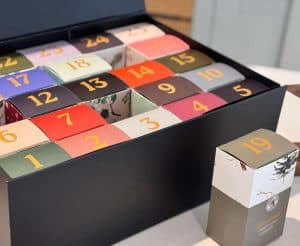 Colorful wool advent calendar with numbered boxes for each day.