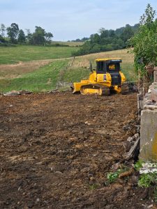 Yellow bulldozer working on land clearing at Ross Farm Mercantile.